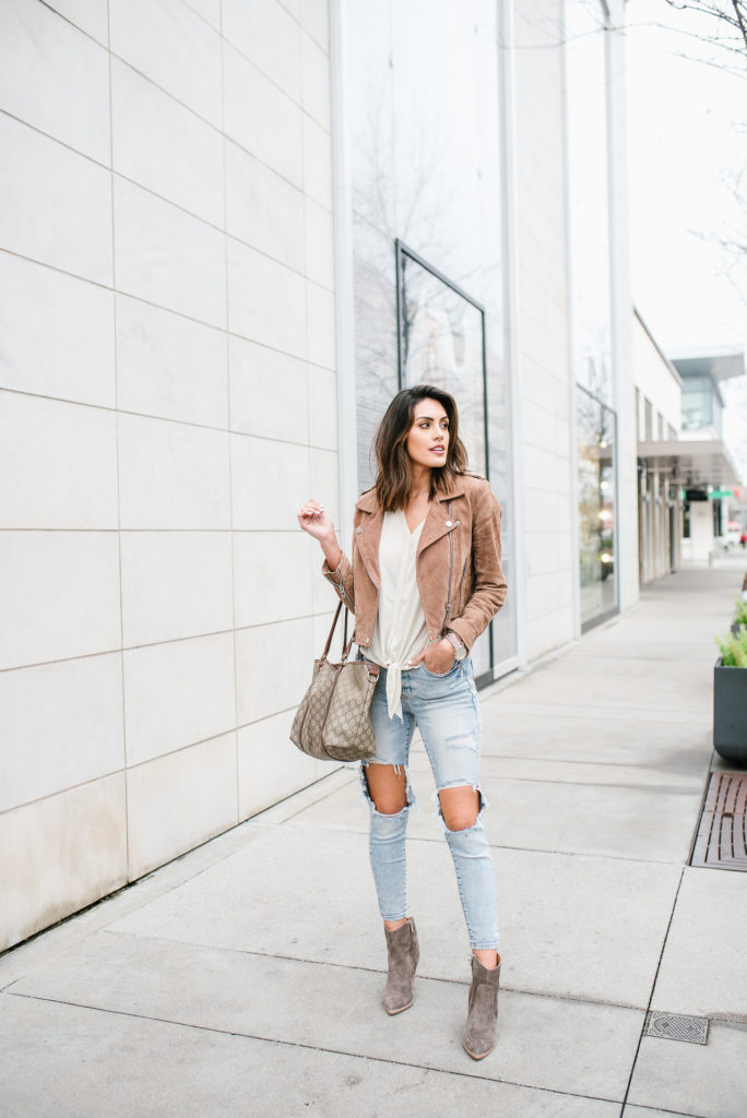 Brown Suede Moto jacket with ripped jeans and tie front top with Marc Fisher Western Boot outfit for rodeo